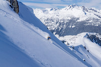 Skier on untouched powder slope in high alpine
