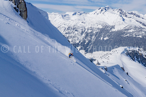 Skier on untouched powder slope in high alpine